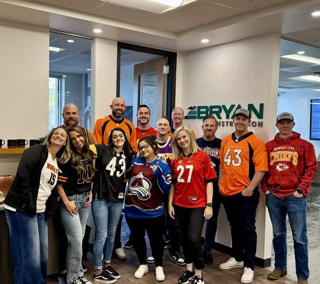 Bryan Construction Denver office team wearing sports jerseys for Jersey Day team culture photo